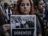 An youth woman holds a placard during a protest in support of sacked academic Nuriye Gulmen and primary school teacher Semih Ozakca, who wer...