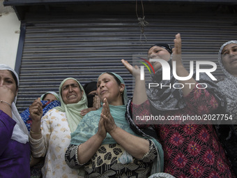 Kashmiri women grieve as they watch the funeral procession of local rebel Adil Ahmed, Saturday, June 17, 2017, on the outskirts of Srinagar,...