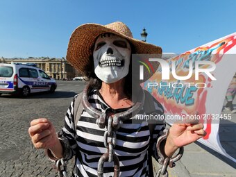 A protester dressed in prisoner with a death’s-head during a demonstration called by the collective 
