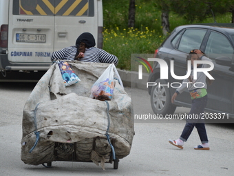 A Syrian refugee mother carries a garbage bag on the road on World Refugee Day in Ankara, Turkey on June 20, 2017. The day is internationall...