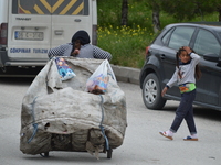 A Syrian refugee mother carries a garbage bag on the road on World Refugee Day in Ankara, Turkey on June 20, 2017. The day is internationall...