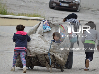 A Syrian refugee mother and her children carry a garbage bag on the road on World Refugee Day in Ankara, Turkey on June 20, 2017. The day is...