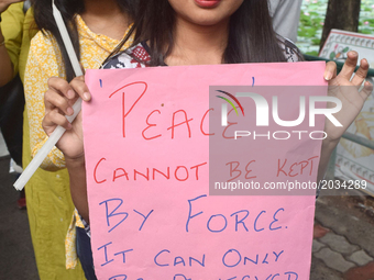 Members of the Gorkha community and JU students hold placards during a protest in support of the Gorkhaland movement in Kolkata on June 20,...