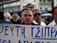 A man holds a placard that reads - Tsipras  liar -  taking part to a rally organized by the Paraitithite (Resign) movement, at Syntagma Squa...