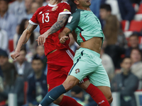Fedor Kudriashov (L) of Russia national team and Andre Silva of Portugal national team vie for a header during the Group A - FIFA Confederat...