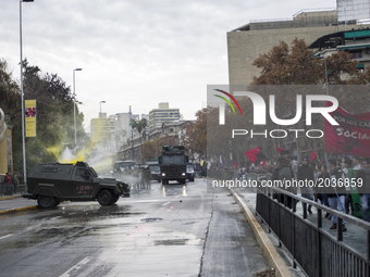 A police water cannon releases a jet of water on a bodycar of a police vehicle on which protesters threw paint.
Led by the Confederation of...