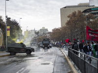 A police water cannon releases a jet of water on a bodycar of a police vehicle on which protesters threw paint.
Led by the Confederation of...