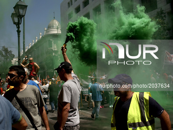 A protester holds a flare outside the Interior Ministry during a protest march organized by the Federation of workers in municipalities in A...
