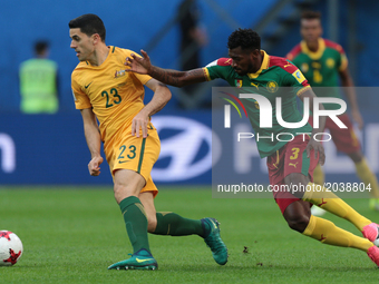Tommy Rogic (L) of the Australia national football team and Andre-Frank Zambo Anguissa of the Cameroon national football team vie for the ba...