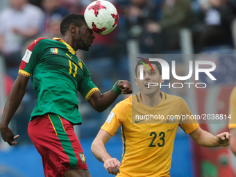 Arnaud Djoum (L) of the Cameroon national football team and Tommy Rogic of the Australia national football team vie for the ball during the...