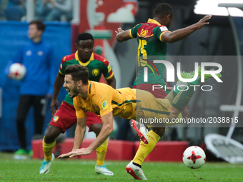 Mathew Leckie (L) of the Australia national football team and Sebastien Siani of the Cameroon national football team vie for the ball during...