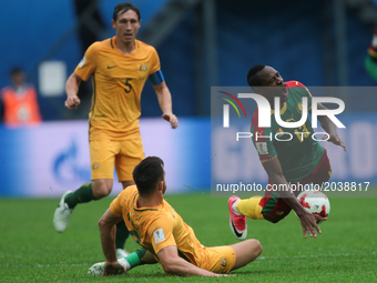 Bailey Wright (L) of the Australia national football team and Christian Bassogog of the Cameroon national football team vie for the ball dur...