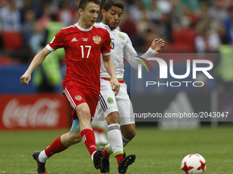 Aleksandr Golovin (L) of Russia national team and Jonathan Dos Santos of Mexico national team vie for the ball during the Group A - FIFA Con...
