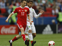 Aleksandr Golovin (L) of Russia national team and Jonathan Dos Santos of Mexico national team vie for the ball during the Group A - FIFA Con...