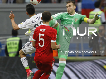 Hirving Lozano (L) of Mexico national team heads the ball to score as Igor Akinfeev (R) of Russia national team defends during the Group A -...