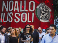 Nina Moric (C), a Croatian fashion model, marches as thousands of members of Italian far-right movement CasaPound from all over Italy march...