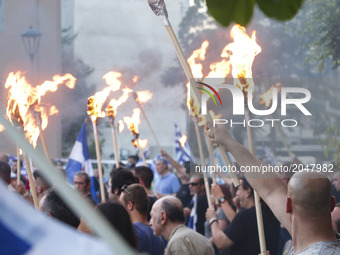 Hundreds of supporters of the nationalist Golden Dawn party held a torch-lit march in Thessaloniki, Greece on 25 June 2017, to protest again...