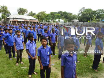 Bangladeshi school students Stand in alignment in a school ground in Manikganj near Dhaka, Bangladesh. On July 1, 2017 (