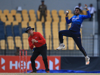 Sri Lankan cricketer Wanindu Hasaranga takes a catch to dismiss Zimbabwe's Sikandar Raza(unseen during the 4th One Day International cricket...