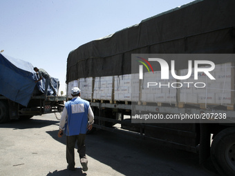 A Palestinian checks a truck loaded with humanitarian aid as it arrives in the Palestinian town of Rafah through the Kerem Shalom crossing b...