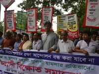 Activists of National Committee to Protect Oil, Gas, Mineral Resources, Power and Ports attend with placard at a rally to protest demanding...