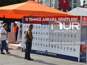 People look at a board with the names of victims marking the 1st anniversary of Turkey's failed coup attempt in Ankara, Turkey on July 14, 2...