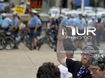 A Trump supporter is seen making a gesture on the sidelines of an Anti-Trump Refuse Racism rally in Center City Philadelphia, Pennsylvania,...