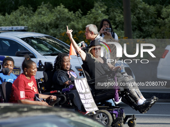 Protestors in wheelchairs lead a Refuse Racism march in Philadelphia, Pennsylvania, on July 15, 2017. (