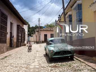 A girl descends to the street on her bicycle in Trinidad Cuba. (