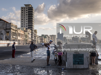 Several people walk the Malecón in Havana on 31 May 2017. (