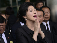 Ousted former Thai Prime Minister Yingluck Shinawatra speaks with members of Thai media as she arrives at the Supreme Court in Bangkok, Thai...