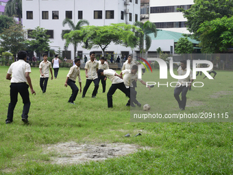 Bangladeshi collage students playing football on the collage ground at class break time in Dhaka city, Bangladesh. On July 23, 2017

 (