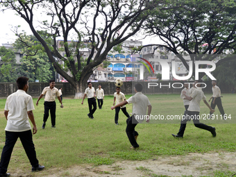 Bangladeshi collage students playing football on the collage ground at class break time in Dhaka city, Bangladesh. On July 23, 2017

 (