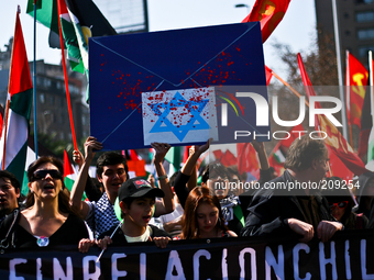 Thousands of people marched through the main avenue of Santiago de Chile, on August 10, 2014 to reach La Moneda presidential palace to show...