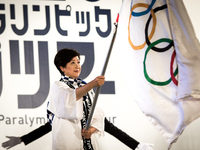Tokyo Gov. Yuriko Koike  carries an Olympic flag during the Tokyo 2020 flag tour festival for the 2020 Games at Tokyo Metropolitan Plaza in...