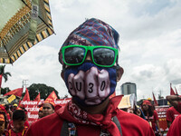 A protester is seen wearing a Duterte mask in an anti-Duterte demostration. President Duterte delivers his second State of the Nation Addres...