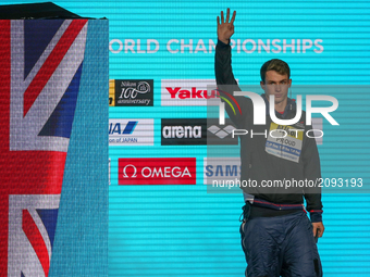 Great Britain's Benjamin Proud celebrates on the podium after the men's 50m butterfly final during the swimming competition at the 2017 FINA...