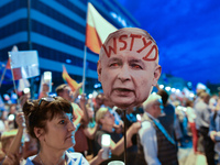 A lady holds an image of PiS Chairman Jaroslaw Kaczynski's face withthe word 'Shame' written on his forehead, during an anti-government cand...
