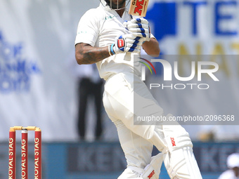 Indian cricketer 
Shikhar Dhawan plays a shot during the 1st Day's play in the 1st Test match between Sri Lanka and India at the Galle Inte...