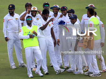 Sri Lankan cricket team members celebrate the wicket of Virat Kohli (unseen) during the 1st Day's play in the 1st Test match between Sri Lan...