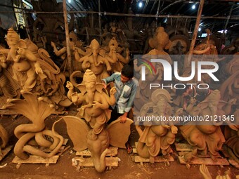 Local artists busy to built clay idols of elephant headed God Ganesha at a workshop ahead of the Ganesha Chatruthi festival in the eastern I...