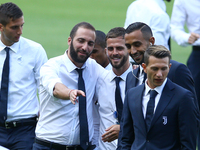Gonzalo Higuain with Miralem Pjanic and Mehdi Benatia of Juventus during the Juventus Walk Around ahead of the Italian Supercup at Olimpico...