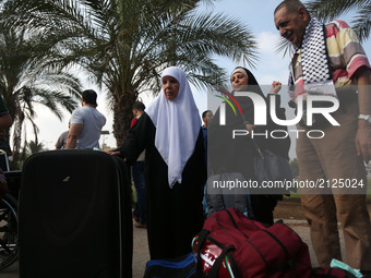 Muslim Palestinian pilgrims walk to a bus en route to the Rafah border between the Gaza Strip and Egypt before leaving for the annual hajj p...