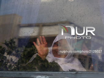 A Palestinian woman is seen through a window en route to the Rafah border between the Gaza Strip and Egypt before leaving for the annual haj...