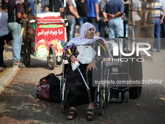 Muslim Palestinian pilgrims walk to a bus en route to the Rafah border between the Gaza Strip and Egypt before leaving for the annual hajj p...