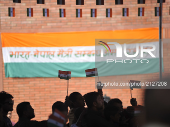 A Nepalese volunteer distributing miniature tricolor India Flag to the people during celebration of India's 71st Independence Day at Kathman...