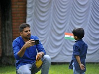 A Father takes pictures of his kid hold tricolor India Flag during celebration of India's 71st Independence Day at Kathmandu, Nepal on Tuesd...