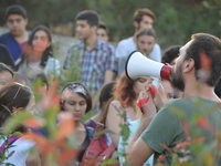 A man speaks into a megaphone as activists gathered in front of the main gate of the Middle East Technical University (METU) to protest agai...