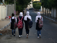 Palestinian schoolboys chat as they head to school on the first day of a new academic year,  in Gaza City on August 23, 2017
 (