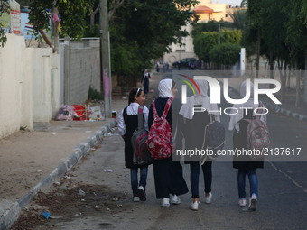 Palestinian schoolgirls chat as they head to school on the first day of a new academic year,  in Gaza City on August 23, 2017  (
